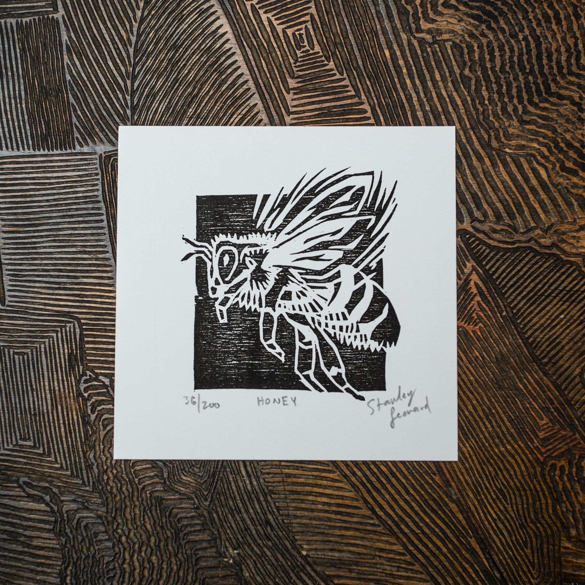 original black and white wood block print of a flying honey bee