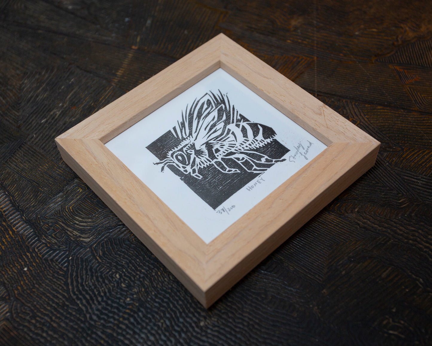 Framed original black and white wood block print of a flying honey bee